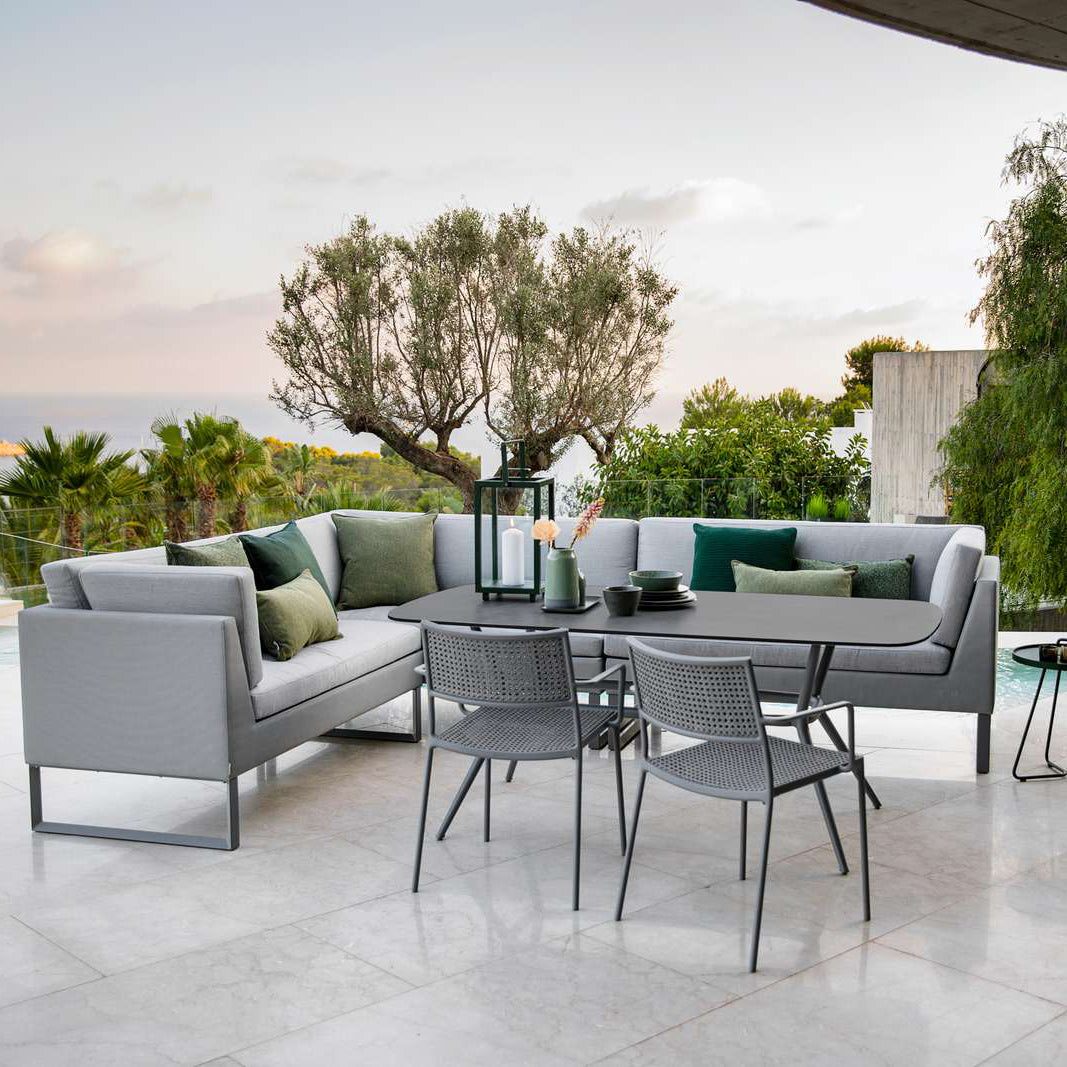 Joy Outdoor Oval Dining Table by Cane-Line, showing joy outdoor oval dining table in live shot.