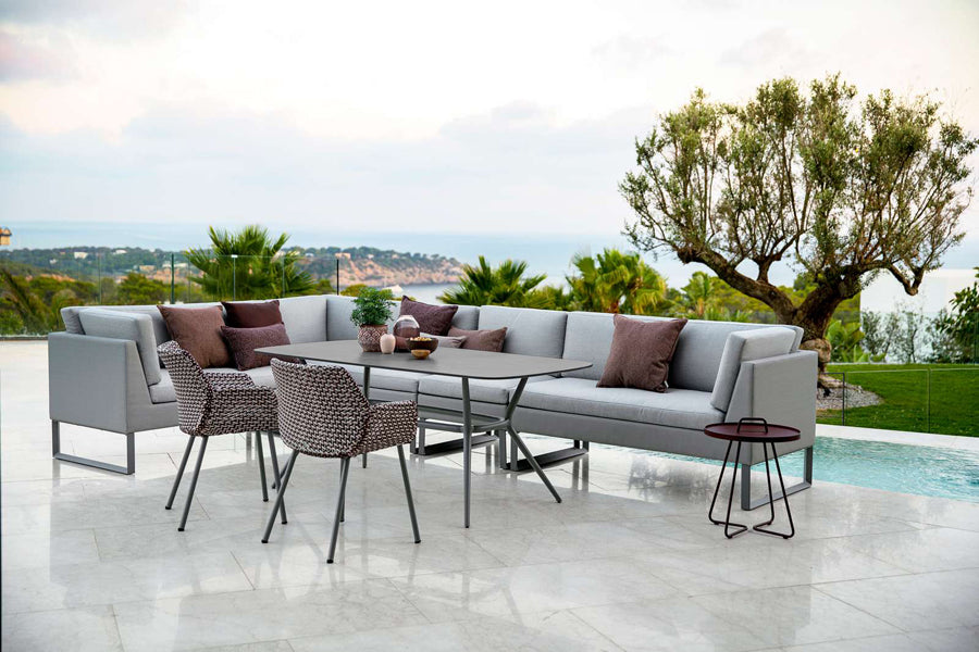 Joy Outdoor Oval Dining Table by Cane-Line, showing joy outdoor oval dining table in live shot.