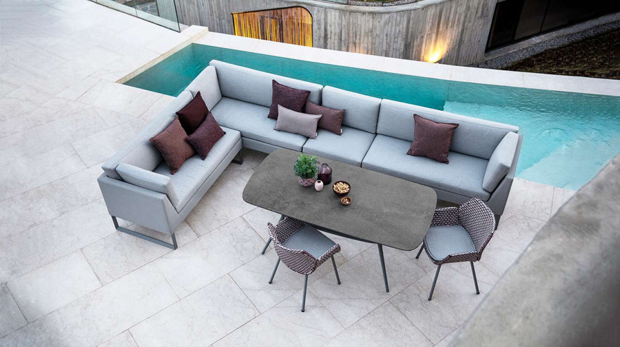 Joy Outdoor Oval Dining Table by Cane-Line, showing joy outdoor oval dining table in live shot.