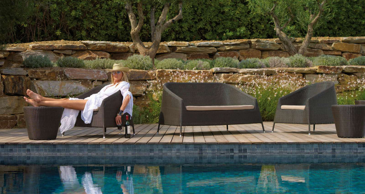 Kingston 2 Seater Stackable Lounge Sofa by Cane-Line, showing kingston 2 seater stackable lounge sofa in live shot.