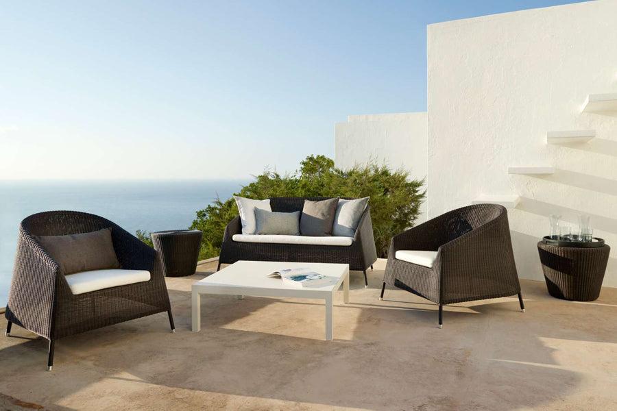 Kingston 2 Seater Stackable Lounge Sofa by Cane-Line, showing kingston 2 seater stackable lounge sofa in live shot.