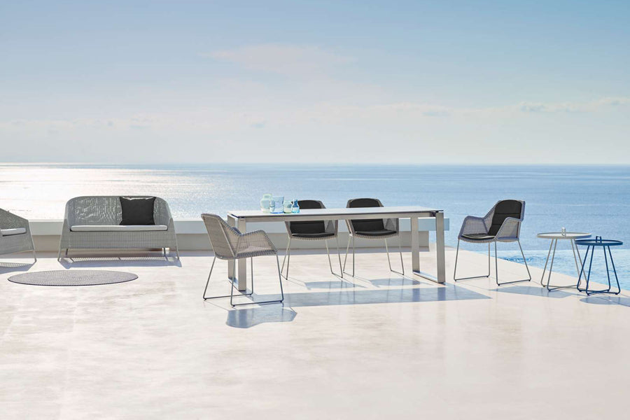 Kingston 2 Seater Stackable Lounge Sofa by Cane-Line, showing kingston 2 seater stackable lounge sofa in live shot.