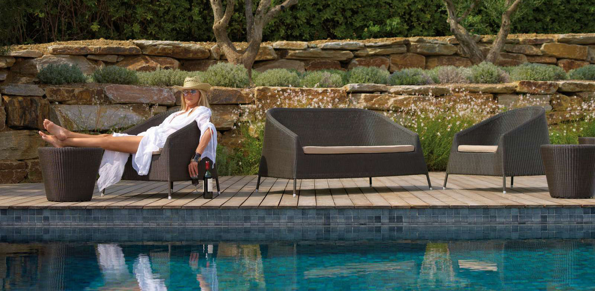 Kingston Lounge Chair by Cane-Line, showing kingston lounge chairs in live shot.