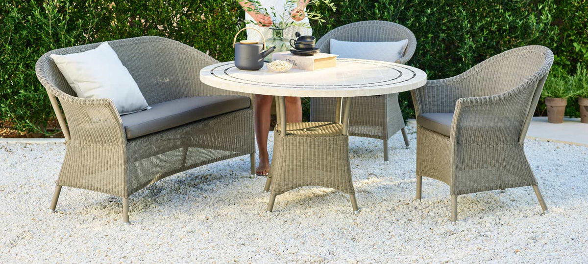 Lansing Table by Cane-Line, showing lansing table in live shot.
