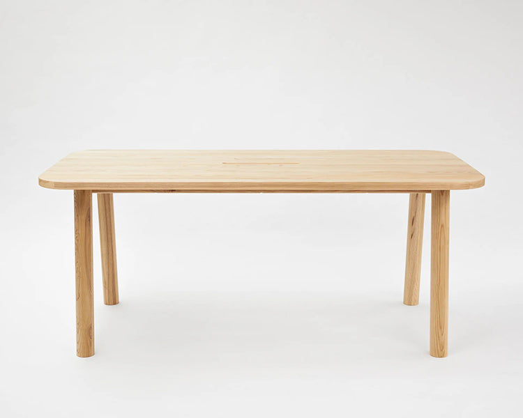 LAX Milk Dining Table by MASHstudios, showing front view of lax milk dining table in solid ash wood.