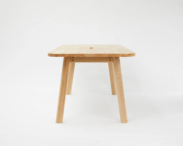 LAX Milk Dining Table by MASHstudios, showing side view of lax milk dining table in solid ash wood.