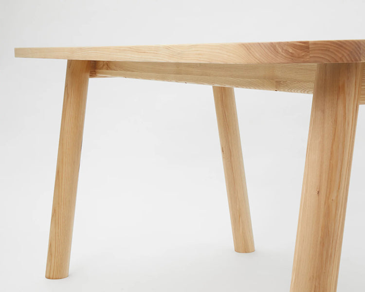 LAX Milk Dining Table by MASHstudios, showing closeup view of lax milk dining table in solid ash wood.