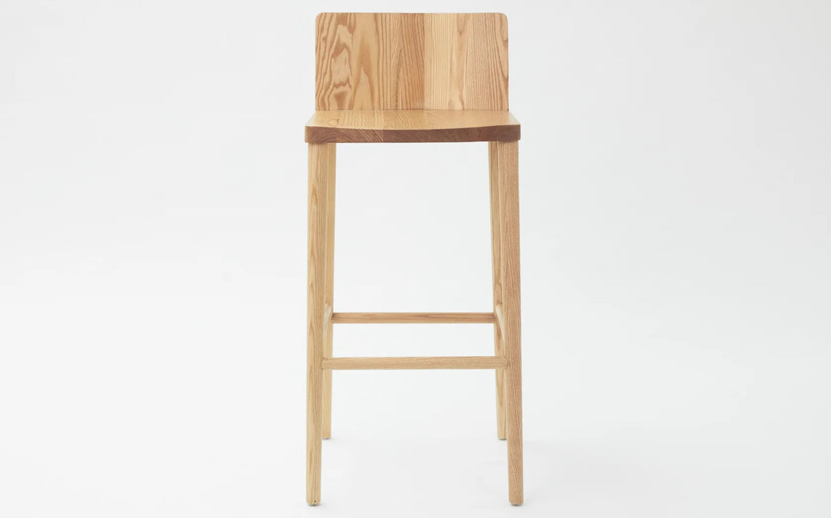 LAX Milk Stool by MASHstudios, showing front view of lax milk stool in bar/solid ash wood.