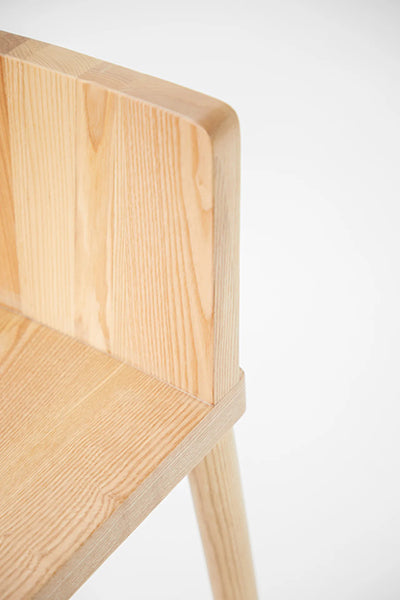 LAX Milk Stool by MASHstudios, showing closeup view of lax milk stool in solid ash wood.