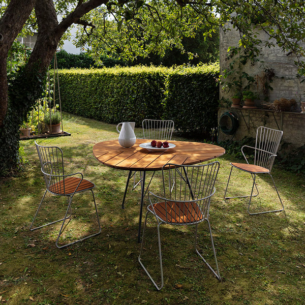 Leaf Outdoor Dining Table by Houe, showing leaf outdoor dining table with chairs in live shot.