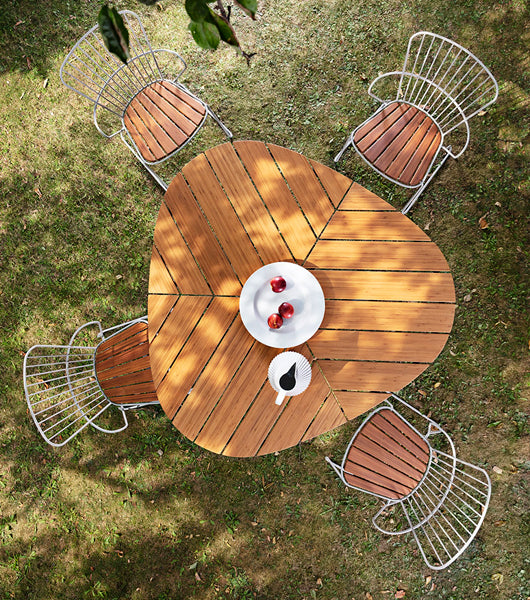 Leaf Outdoor Dining Table by Houe, showing leaf outdoor dining table with chairs in live shot.