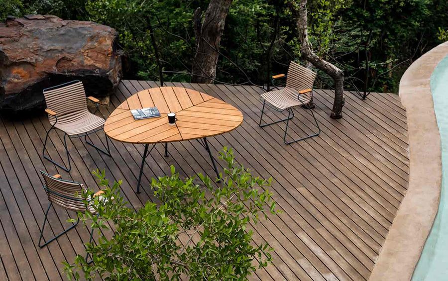 Leaf Outdoor Dining Table by Houe, showing leaf outdoor dining table with chairs in live shot.