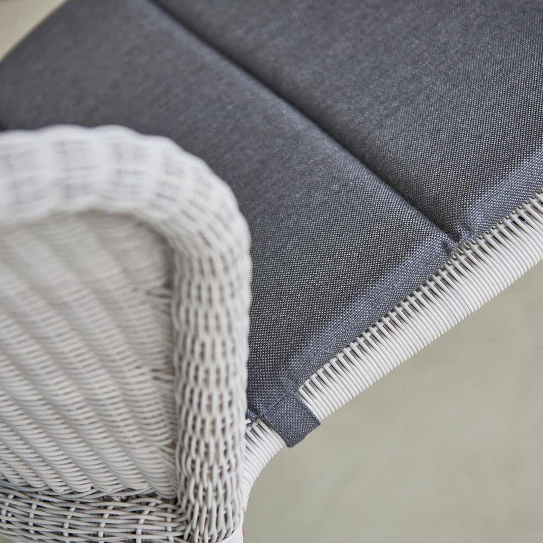 Lean Stackable Dining Chair by Cane-Line, showing closeup view of lean stackable dining chair in live shot.