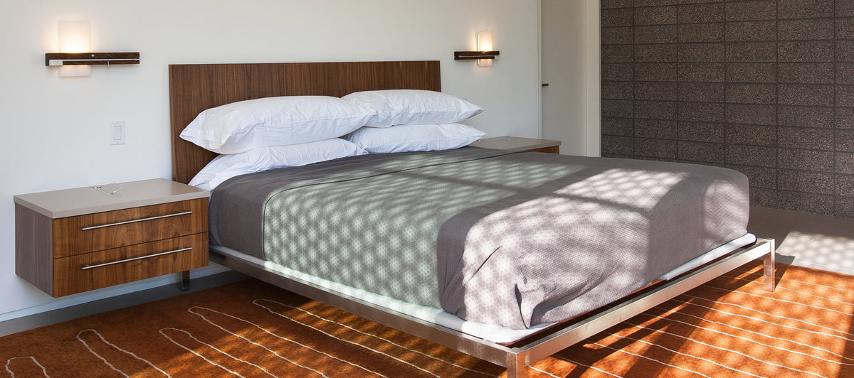 Levo LED Wall Sconce / Reading Light by Cerno, showing levo led wall sconce/reading lights with bed in live shot.