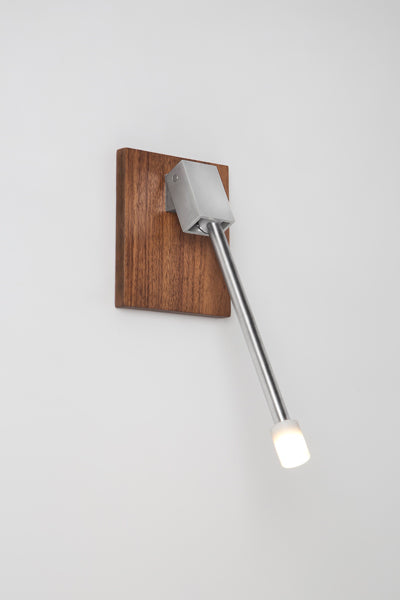 Libri LED Reading Sconce by Cerno, showing libri led reading sconce with walnut backplate in live shot.