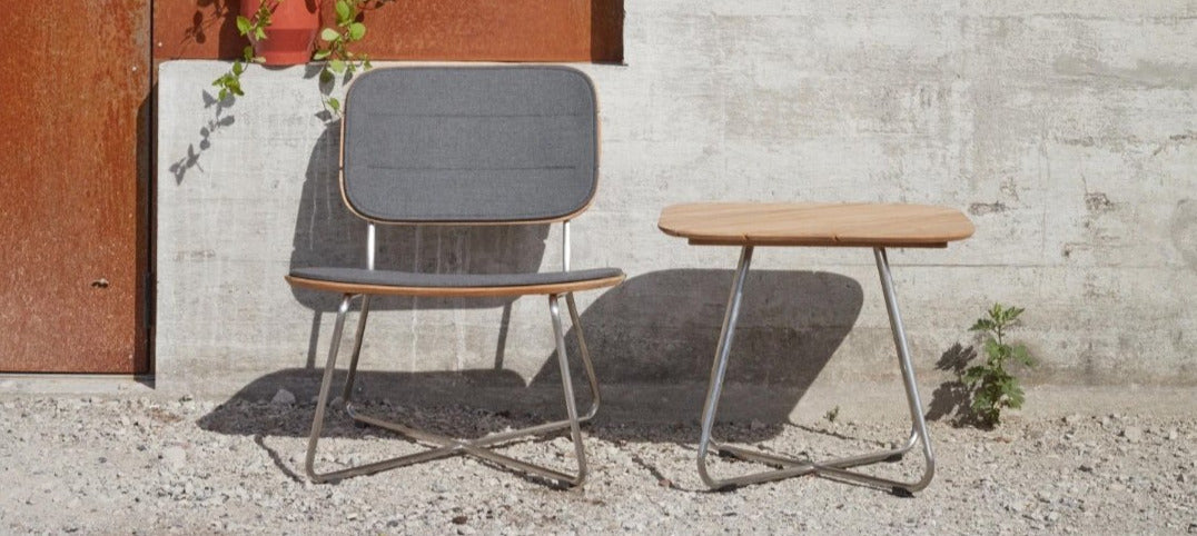 Lilium Teak Lounge Chair by Skagerak, showing Lilium teak lounge chair with lounge table in live shot.