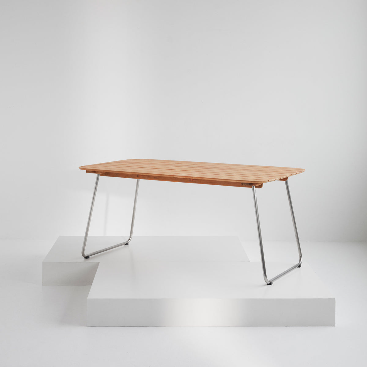 Lilium Teak Table by Skagerak, showing lilium teak table in live shot.
