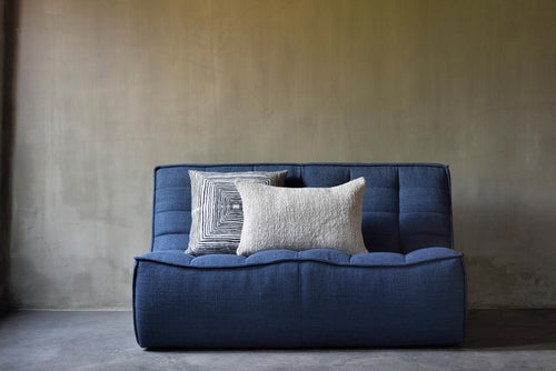 Linear Square Cushion by Ethnicraft, showing square cushion with throw in live shot.