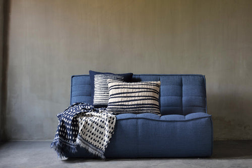 Lines Square Cushion by Ethnicraft, showing square cushion with throw in live shot.