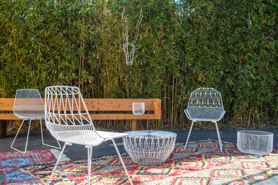 Lucy Side Dining Chair by Bend, showing lucy side dining chairs with baskets & bench in live shot.
