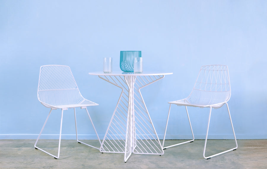 Lucy Side Dining Chair by Bend, showing lucy side dining chairs with table in live shot.