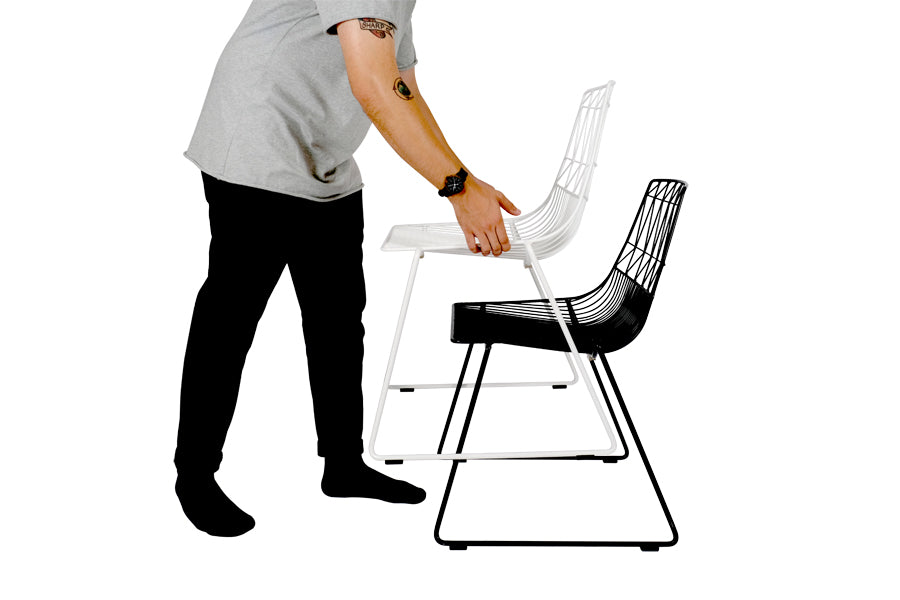 Lucy Stacking Chair by Bend, showing side view of lucy stacking chair in white & black.