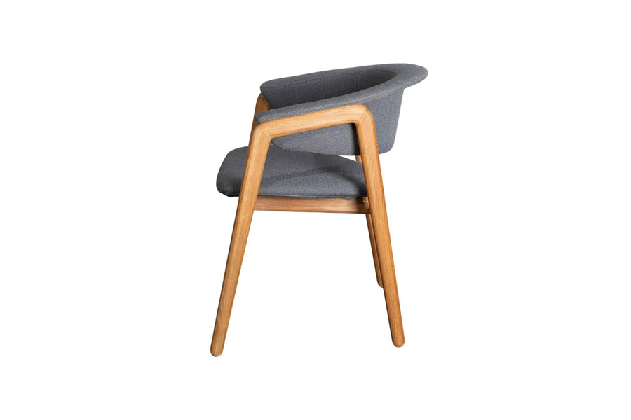 Luna Dining Chair by Cane-Line, showing side view of luna dining chair in teak wood/grey airtouch cushion.
