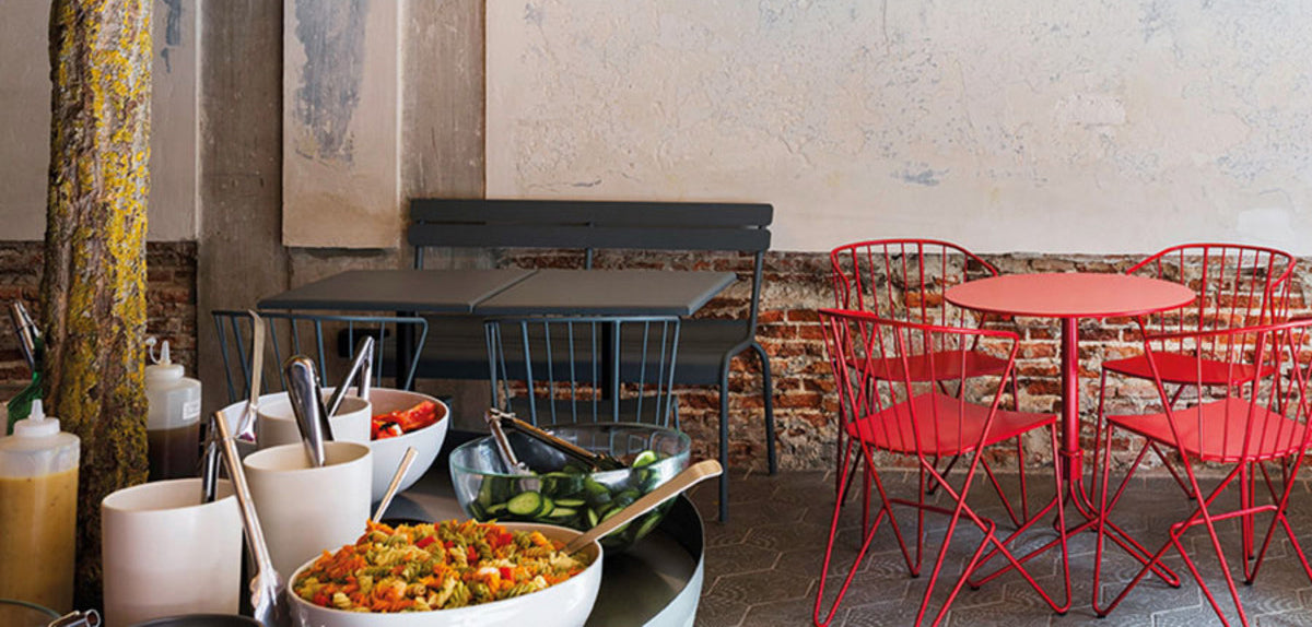 Luxembourg 2 Seater Bench by Fermob, showing live shoot of the bench with chairs.