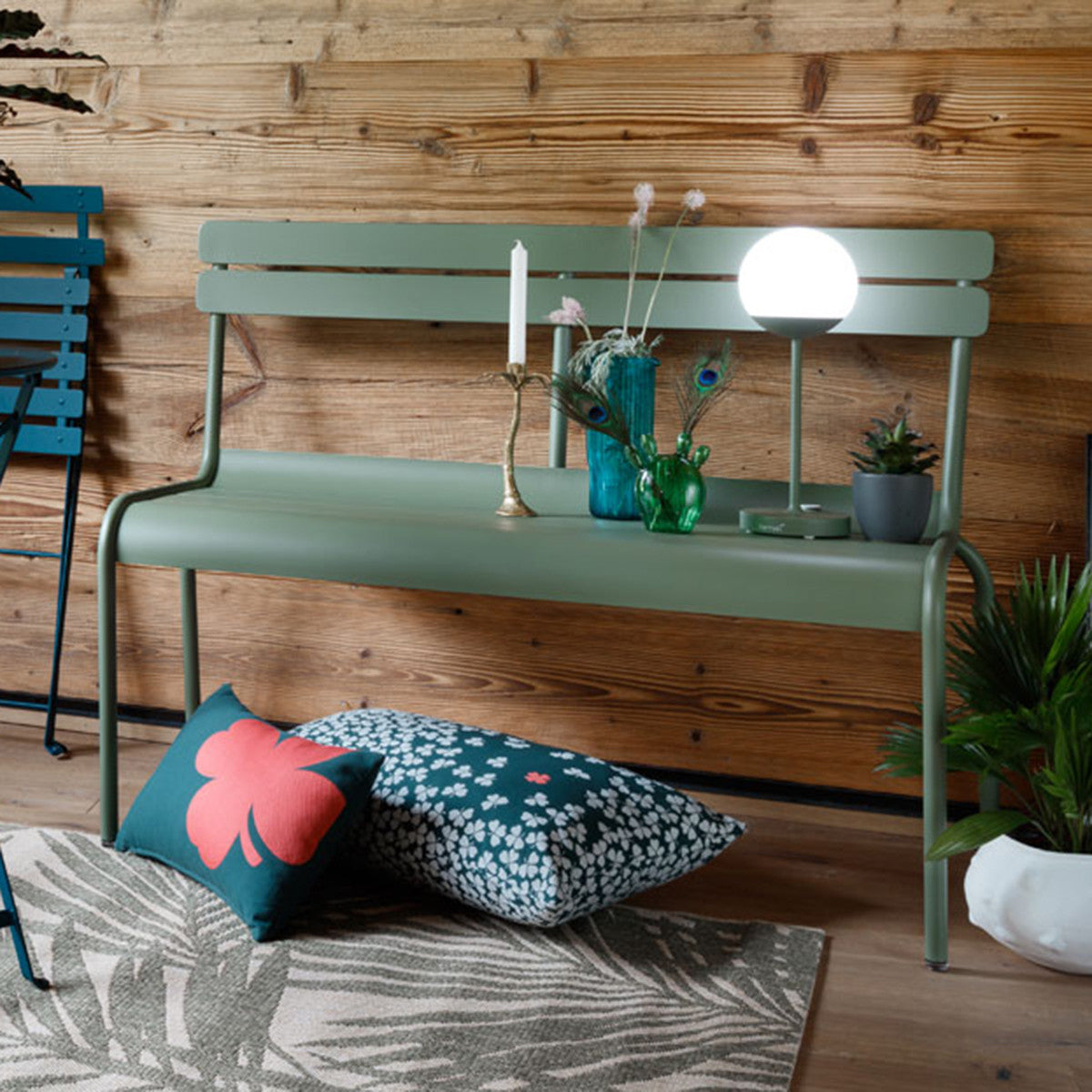 Luxembourg 2 Seater Bench by Fermob, showing front view of bench with chair in the live shot.