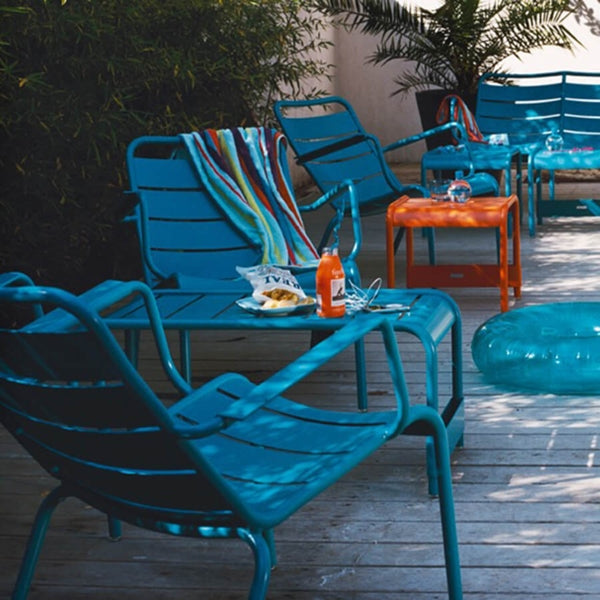 Luxembourg Low Armchair by Fermob, showing low armchairs with benches in live shot.