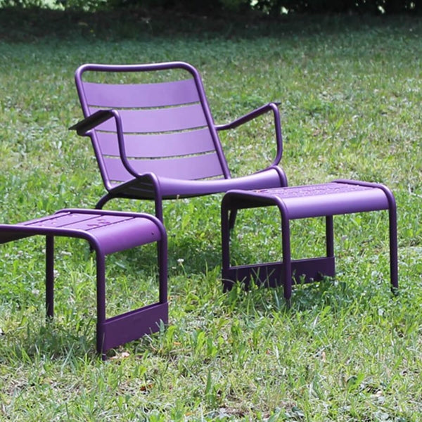Luxembourg Low Armchair by Fermob, showing low armchairs with end table in live shot.