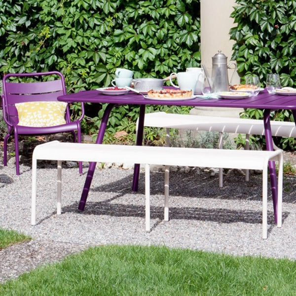 Luxembourg Low Armchair by Fermob, showing low armchairs with bench, table & pillow in live shot.