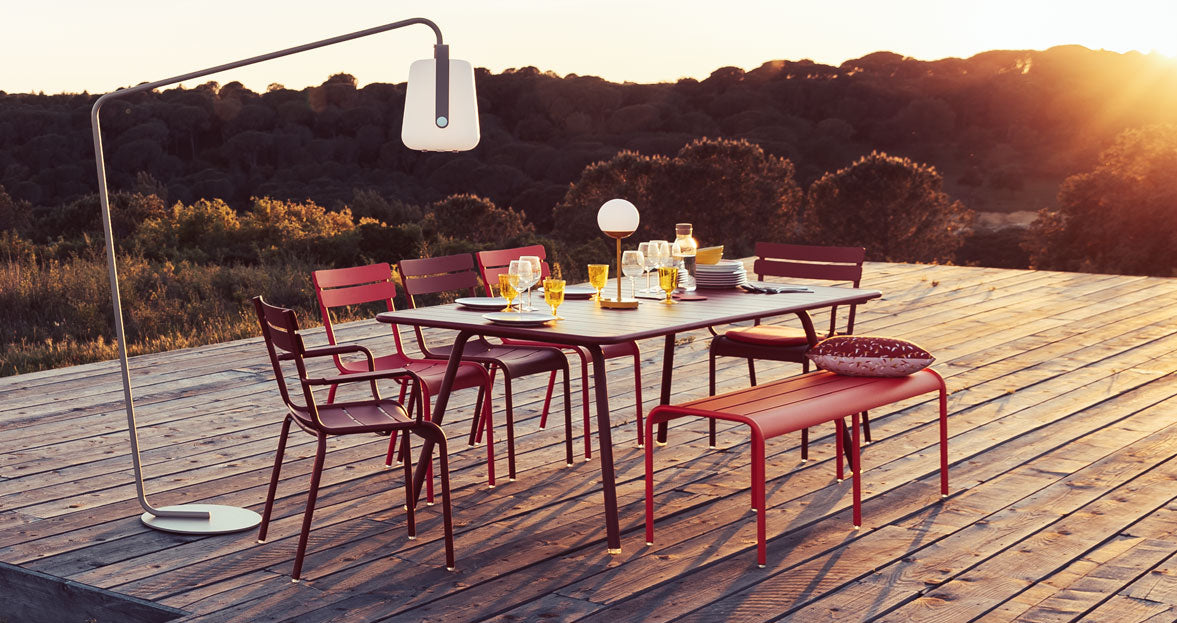 Luxembourg Rectangular Table by Fermob. showing angle view of recutangular table with chairs in the live shot.