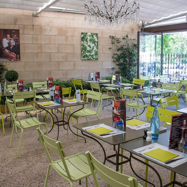 Luxembourg Stacking Side Chair by Fermob, showing side chairs with tables in live shot.