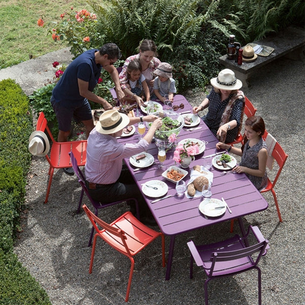 Luxembourg Stacking Side Chair by Fermob, showing side chairs with table in live shot.