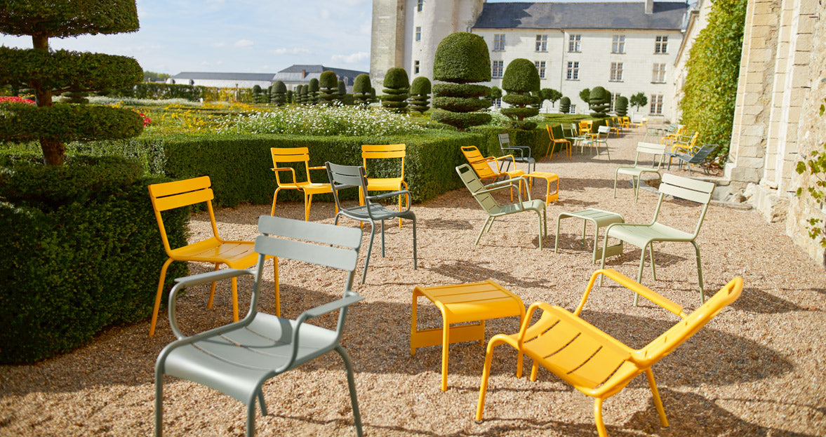 Luxembourg Small Low Table / Footrest by Fermob, showing angle view of low table with chairs in the live shot.
