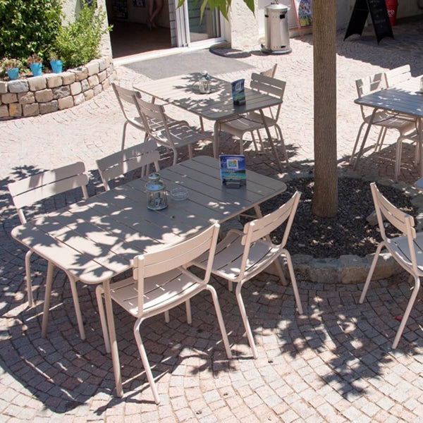 Luxembourg Rectangular Table by Fermob, showing rectanle tables 56" x 32" with chairs in live shot.