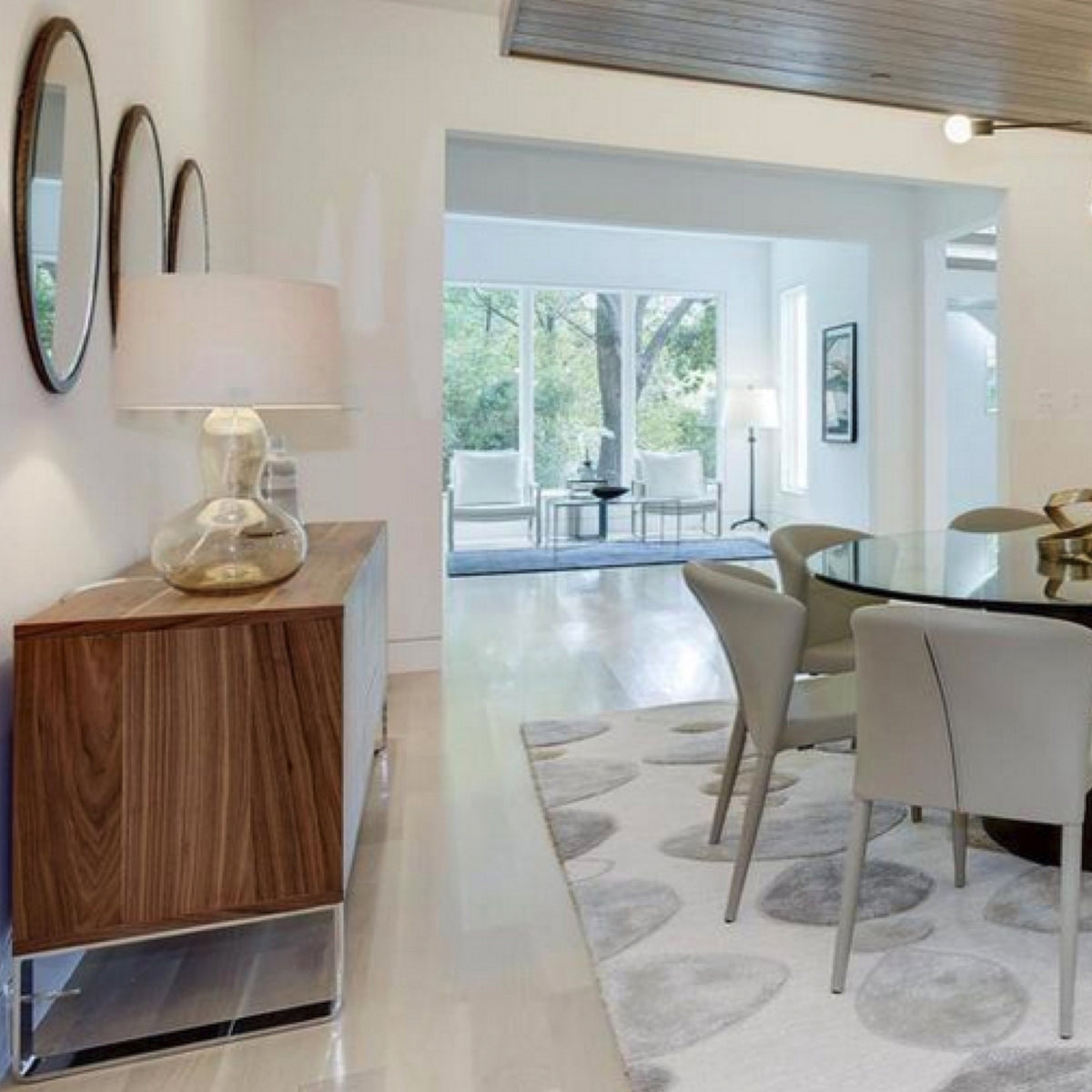 Malta Sideboard by SohoConcept, showing side view of sideboard with table and chairs in live shot.