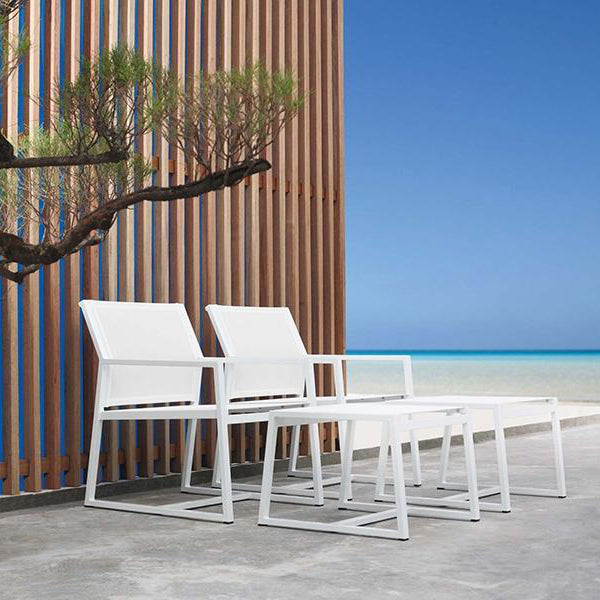Allux Footrest by Mamagreen, showing two footrests with two casual armchirs in live shot.