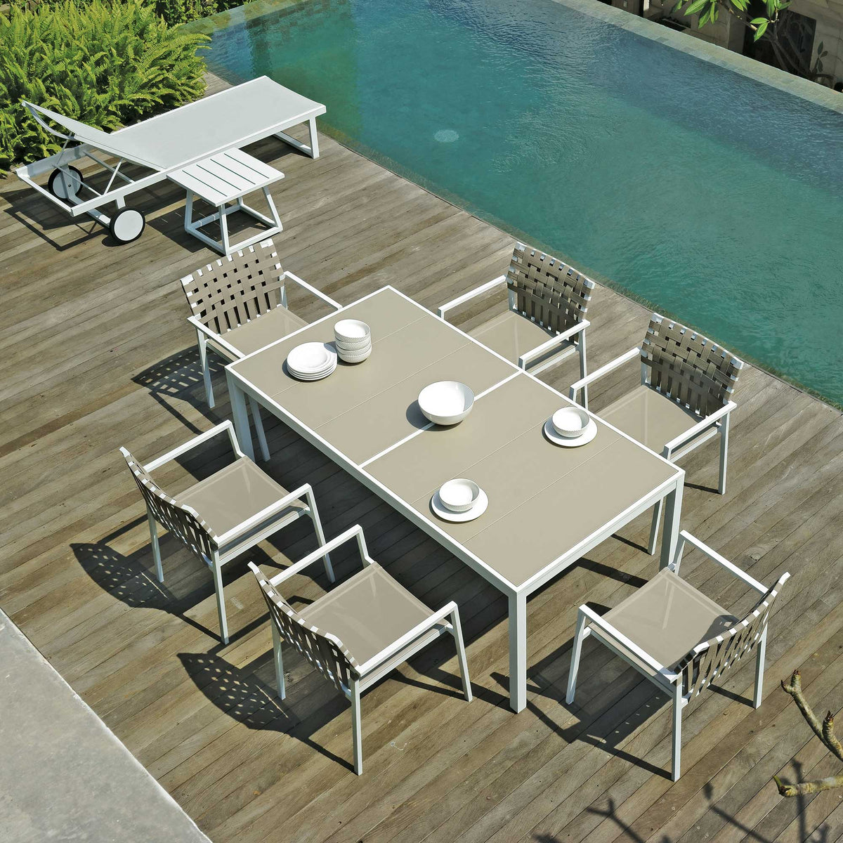 Allux Aluminum Wheels Lounger by Mamagreen, showing lounger, side table, dining table and chairs in live shot.