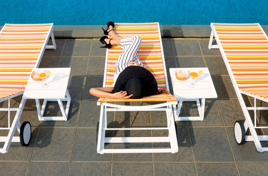 Allux Side Table by Mamagreen, showing side table and lounger in live shot.