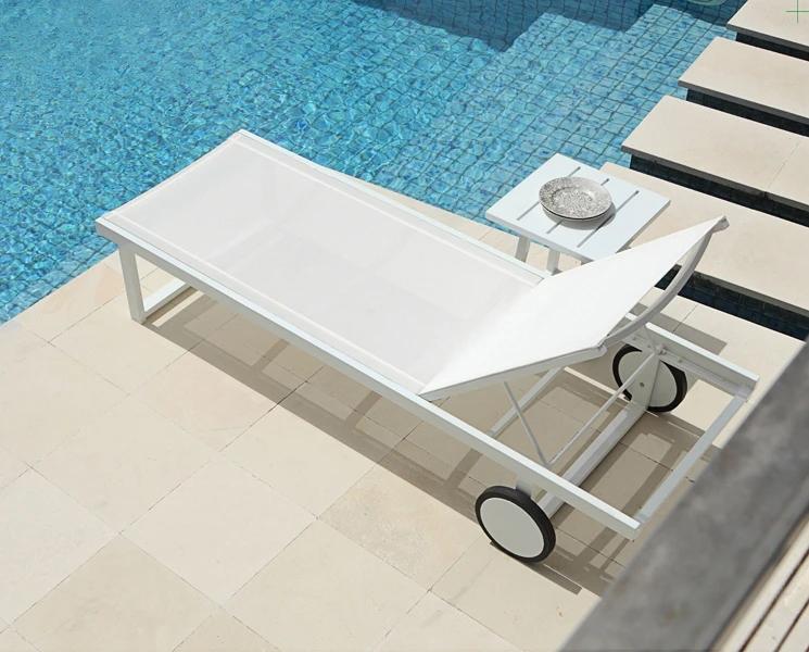 Allux Side Table by Mamagreen, showing side table and lounger in live shot.