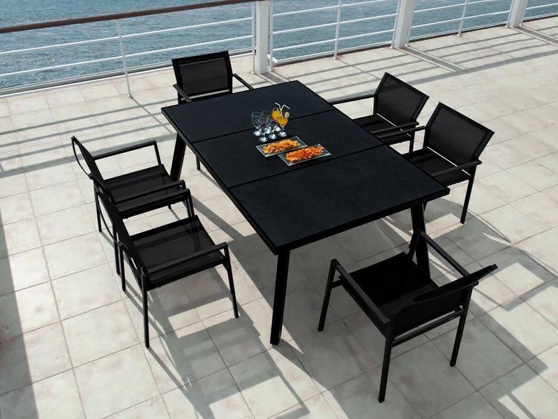 Allux Stacking Armchair by Mamagreen, showing stackable armchairs and dining table in live shot.