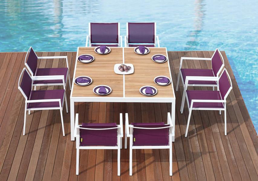 Allux Stacking Armchair by Mamagreen, showing stackable armchairs and dining table in live shot.