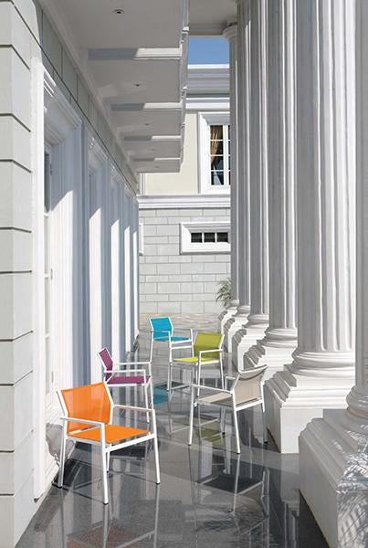Allux Stacking Armchair by Mamagreen, showing stackable armchairs in live shot.