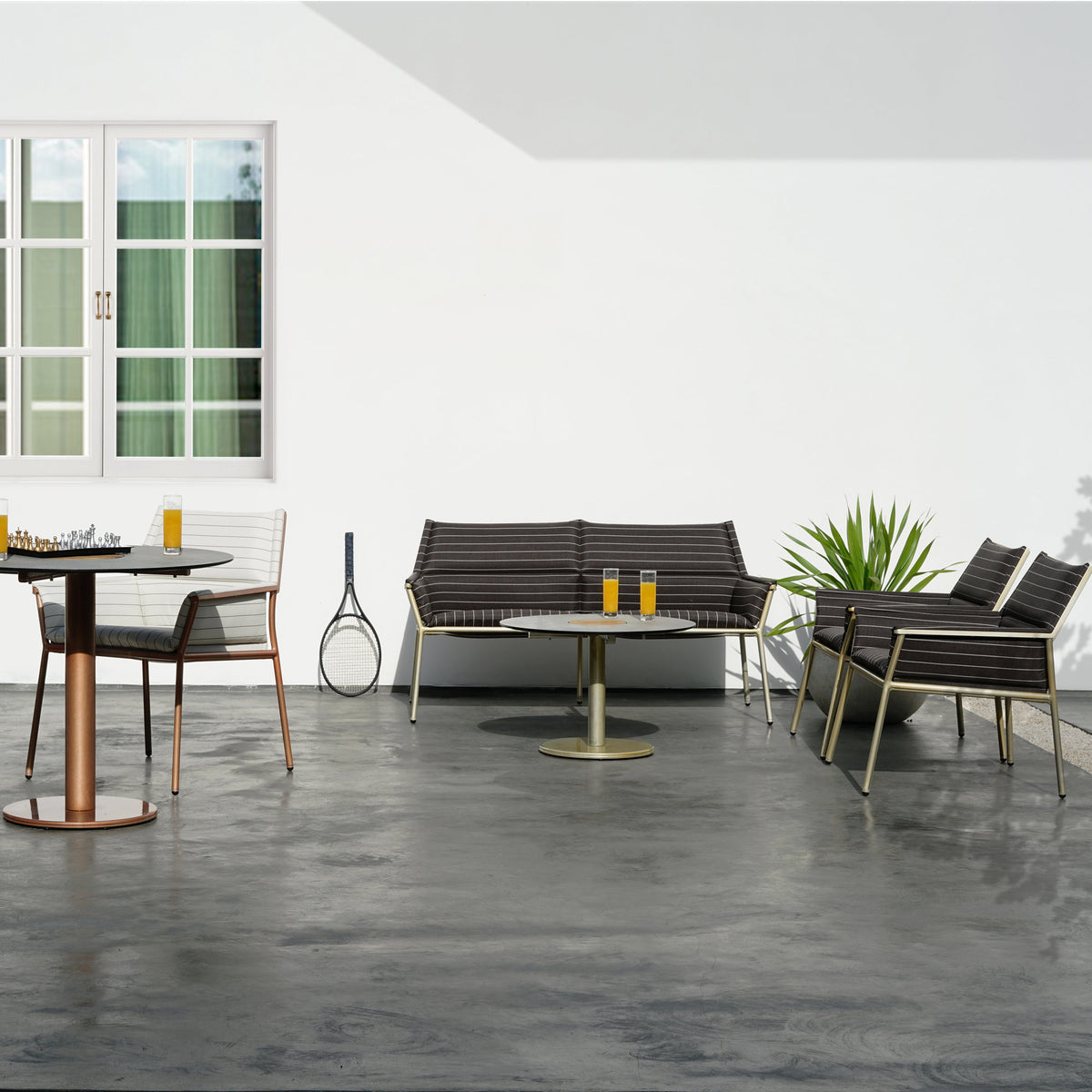 Andy Easy Chair by Mamagreen, showing andy easy chairs with dining chair, 2 seater sofa and tables in live shot.