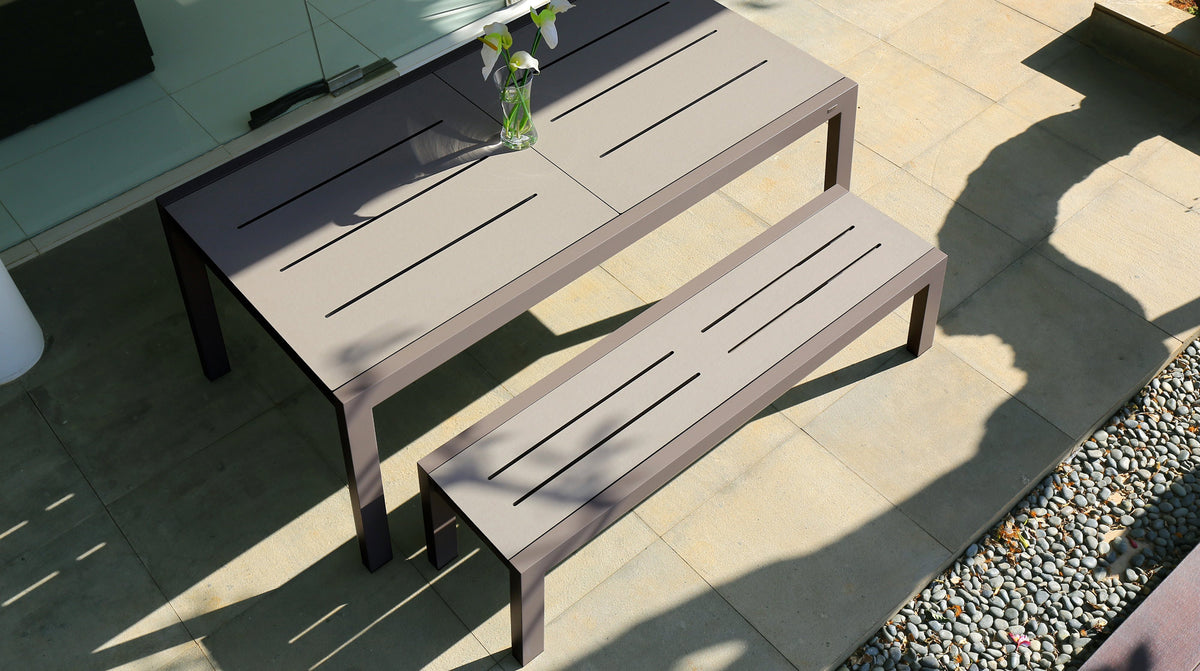 Baia HPL Aluminum 57" Bench by Mamagreen, showing baia hpl aluminum 57" bench with hpl aluminum extendable 67" dining table in live shot.