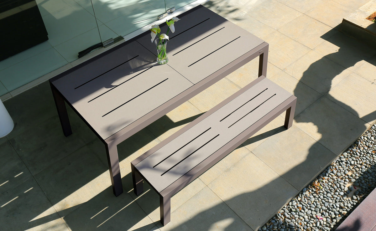 Baia HPL Aluminum Extendable 67" Dining Table by Mamagreen, showing baia hpl aluminum extendable 67" dining table with 57" baia hpl bench in live shot.