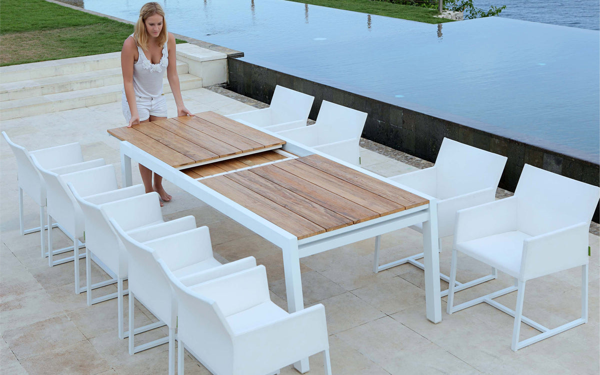 Baia Teak Aluminum Extendable Dining Table by Mamagreen, showing baia teak aluminum extendable dining table with mono dining chair in live shot.