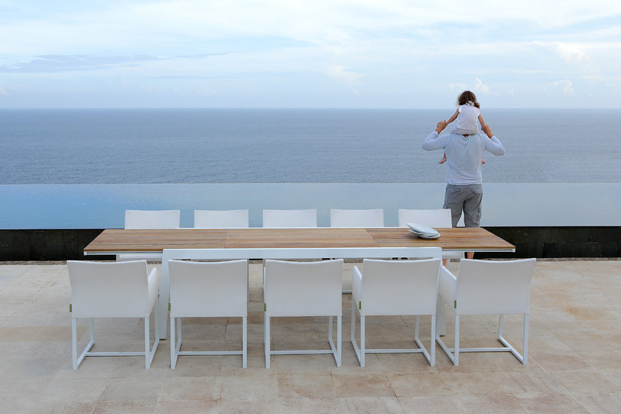 Baia Teak Aluminum Extendable Dining Table by Mamagreen, showing baia teak aluminum extendable dining table with mono dining chair in live shot.
